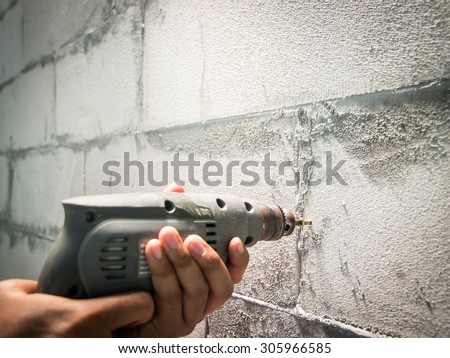Drilling a hole to a wall in house