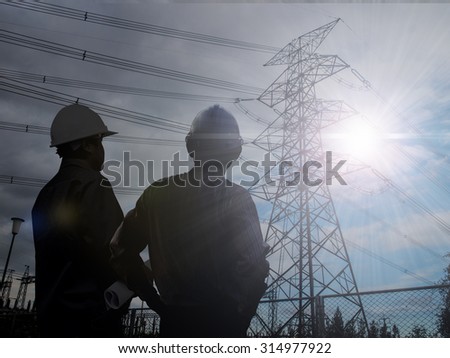 silhouette engineer  in a building site over Blurred substation