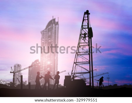 silhouette engineer  in a building site over Blurred construction worker on construction site