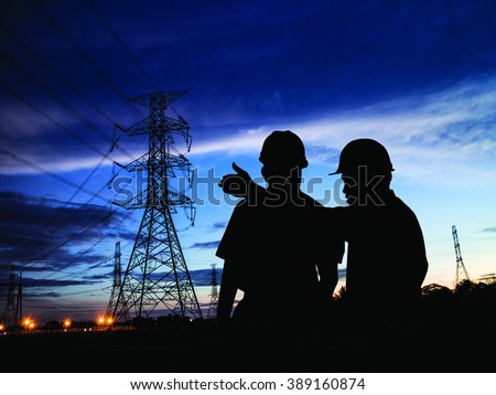 silhouette man survey and civil engineer stand on ground working in a land building site over Blurred construction worker on construction site. examination, inspection, survey