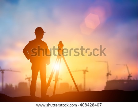silhouette  young engineer working construction standards in line with global construction environment and the environment around the work site. over Blurred construction worker on construction site