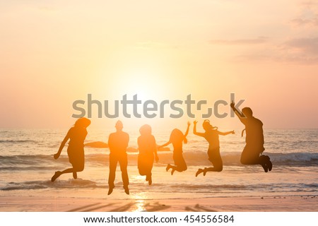 Silhouette friends jumping with joy and happiness over blurred, sand and sea. They love each other as longtime friends. I promise not to leave each other. Concept friends. concept happy.