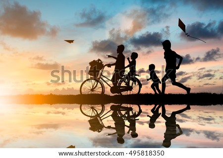 Children and friend ride bikes and chasing paper airplanes and kites have fun. While living with the outside world.Education outside the classroom, family, friends concept.