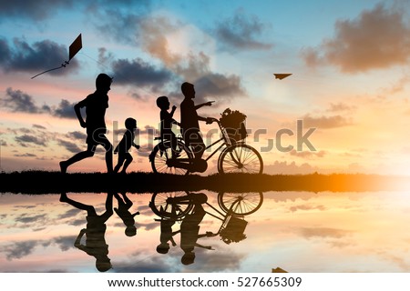Children ride bikes and chasing paper airplanes and kites have fun. While living with the outside world.Education outside the classroom, family, friends concept.
