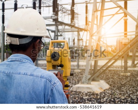 Success venture business growth.progress and potential concepts.Surveyor engineer on the substation over blurred employees at Construction Site.flare light