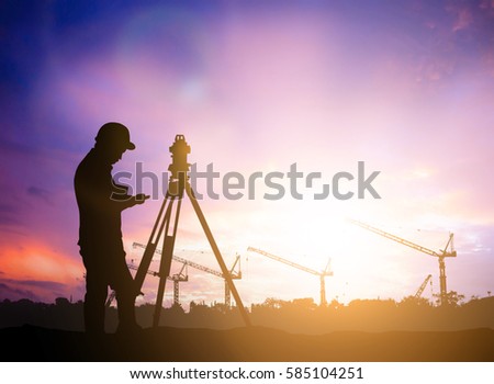 silhouette survey engineer working  in a building site over Blurred construction worker on construction site