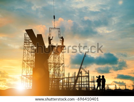 Silhouette engineer  look team construction safely to work load scaffolding over blurred background sunset pastel for industry background with Light fair