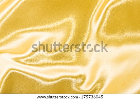Golden satin or silk background with beautiful waves