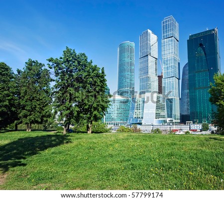 Technology versus nature, modern skyscrapers and green trees