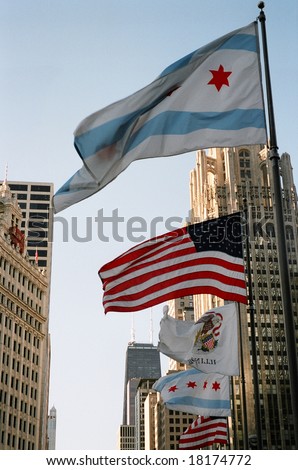 high houses in the city of Chicago with the American flag and the flag of Illinois in the foreground