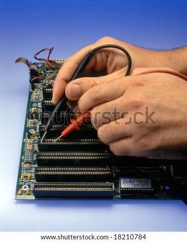 a man measures the contacts of a mainboard of a computer, detail