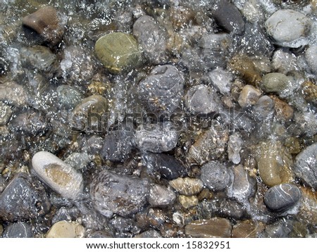 pebble washed streaming sea water, and forming background, invoice