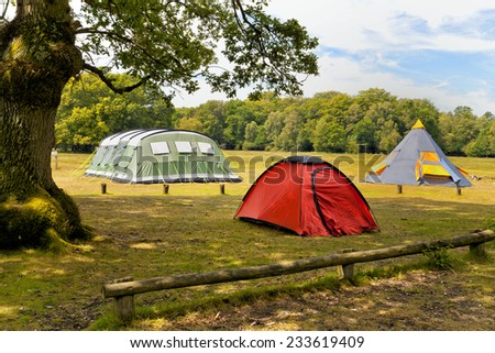 Three big colorful tents in woodlands campground