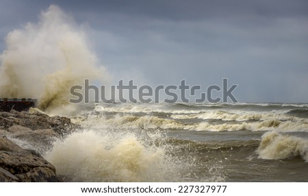 Waves crashing against rocks and spraying into the air