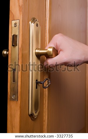 Hand on a handle wooden door to open or close it