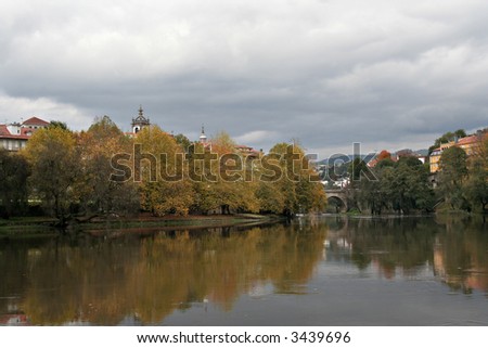 River landscape in autumn season over cloudy sky