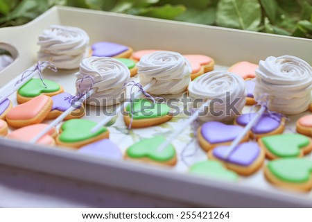 Delicious sweet buffet with heart-shaped cookies and marshmallow on sticks