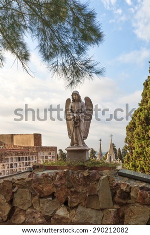 Barcelona, Spain - July 5, 2012: Cementiris de Barcelona. catholic cemetery angel sculpture