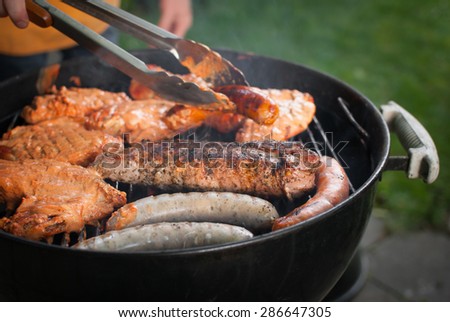 Garden grilling of sirloin steak, tandoori chicken breasts, Bavarian sausages - Barbecue garden party invitation background