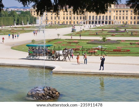 VIENNA, AUSTRIA - AUGUST 8, 2013: Schonbrunn Palace and Gardens on August 8, 2013, Vienna. Schonbrunn Palace is a former imperial 1441-room Rococo summer residence, designed to glorify Habsburg power.
