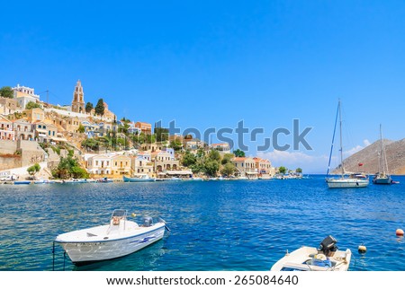 SYMI, GREECE - AUGUST 02, 2014: Fishing boats moored in Yialos harbour on August 02, 2014 on Symi island, Greece. Yialos, the main harbour on Symi, is a popular destination for day trips from Rhodes.
