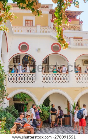 SYMI, GREECE - AUGUST 02, 2014: Famous Panormitis monastery is visited by people from all over the world pay homage to St Michael of Panormitis . The Island of Symi  on August 02, 2014