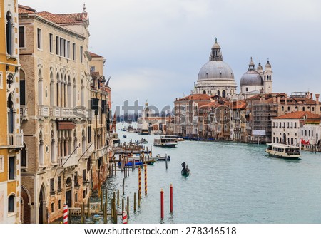 VENICE, ITALY - JANUARY 23, 2015: The Grand Canal and the Basilica Santa Maria della Salute in a cloudy day in Venice on  January 23, 2015 in Venice. The Grand Canal is the largest canal in Venice