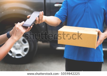 messenger man hold box and talk on smart phone and payment terminal in hands, Package delivery concept