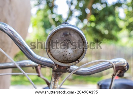 very old bicycle with old metal headlight
