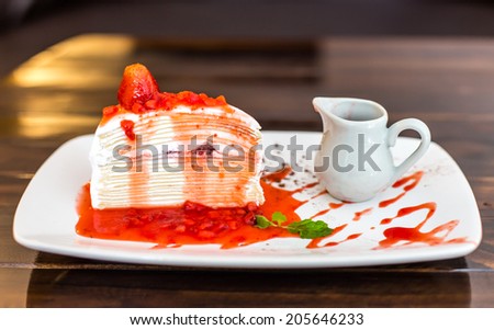 Crepe cake with strawberry sauce.