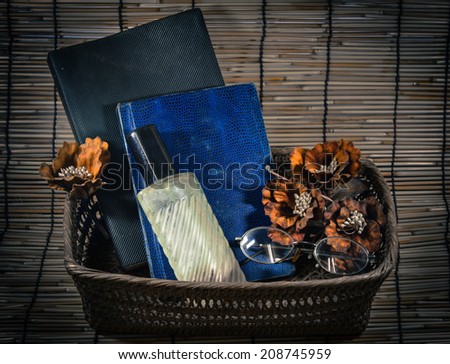 Vintage still life with old spectacles and perfume on book.