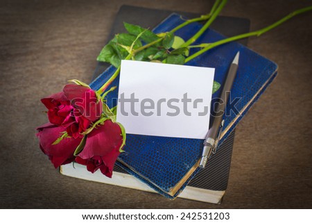 Roses on old books and glasses and white for text.