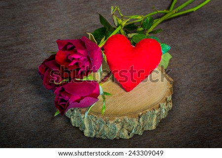 Roses on old books and glasses, small heart on wood timber
