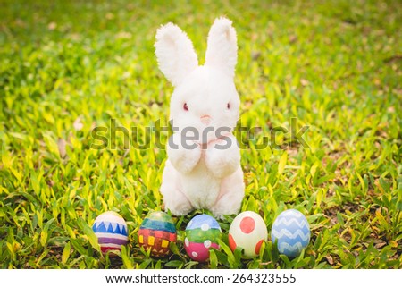 Sugar rabbit and easter eggs on meadow