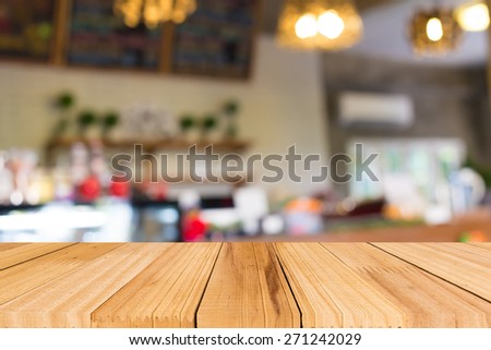 Selected focus empty brown wooden table and Coffee shop blur background with bokeh image
