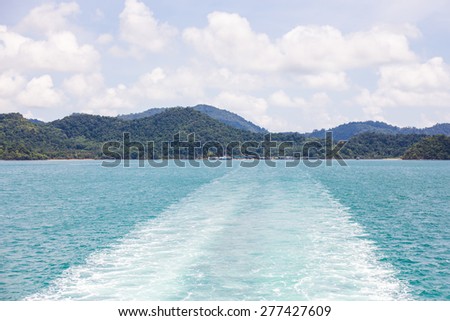 The wake of a boat as seen from the stern of a ship
