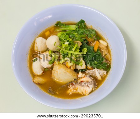 Fish soup with vegetables and pasta.