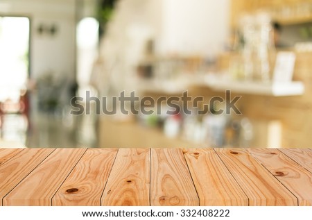 Selected focus empty brown wooden table and Coffee shop blur background with bokeh image, for product display montage