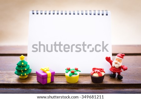 Notebook to display your artworks. with cute vintage christmas new year gifts mock up on wooden background