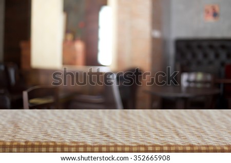 Checkered table cloth on empty table for Your photomontage or product display.
