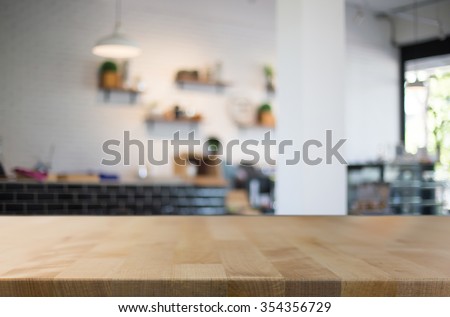 Selected focus empty brown wooden table and Coffee shop blur background with bokeh image. for your photomontage or product display.