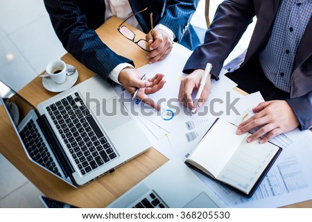 Business team working on a new business plan with modern digital computer. Top view shot