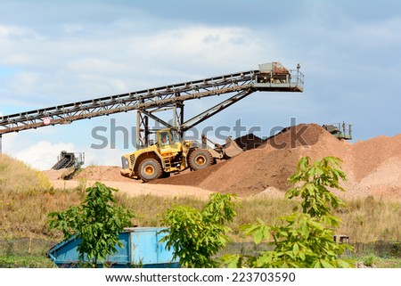 Digger and conveyor belt at quarry