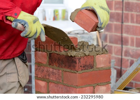 Bricklaying - laying brick to make a gate post