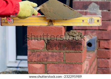 Bricklaying checking brick is level