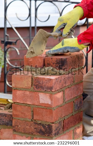 Bricklaying - laying brick to make a gate post