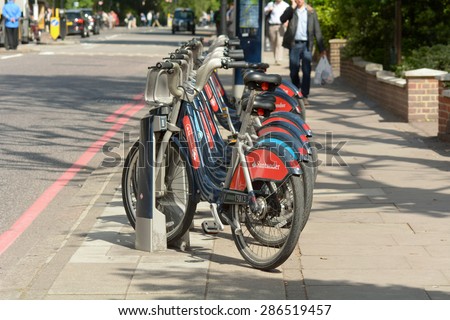 LONDON, ENGLAND  May 25: Transport for London bike hire  Bikes (Boris bikes) for hire by public, locals, commuters and tourists in bike rack, shown on 25 May 2015 in London.