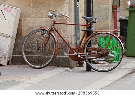 BORDEAUX, FRANCE â?? June 23, 2015: Bicycle chained to lamppost in the centre of the city whilst owner shops.