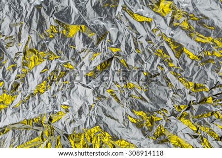 crumpled yellow foil wrapping paper