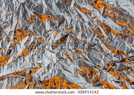 crumpled orange foil wrapping paper